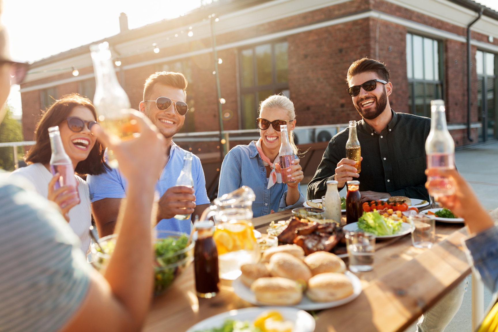 Happy Friends with Drinks or Bbq Party on Rooftop